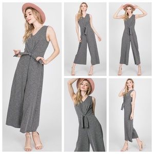 Sleeveless, cropped front knot jumpsuit in black.